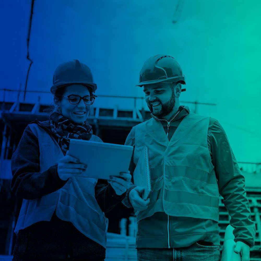 Two workers discussing on construction site.