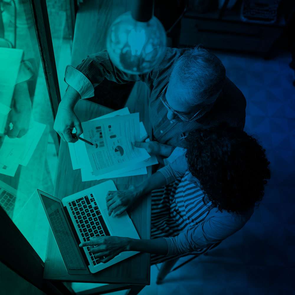 Two people collaborating over documents