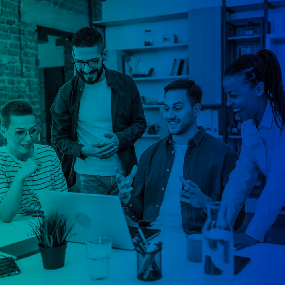 Group discussing ideas around laptop.