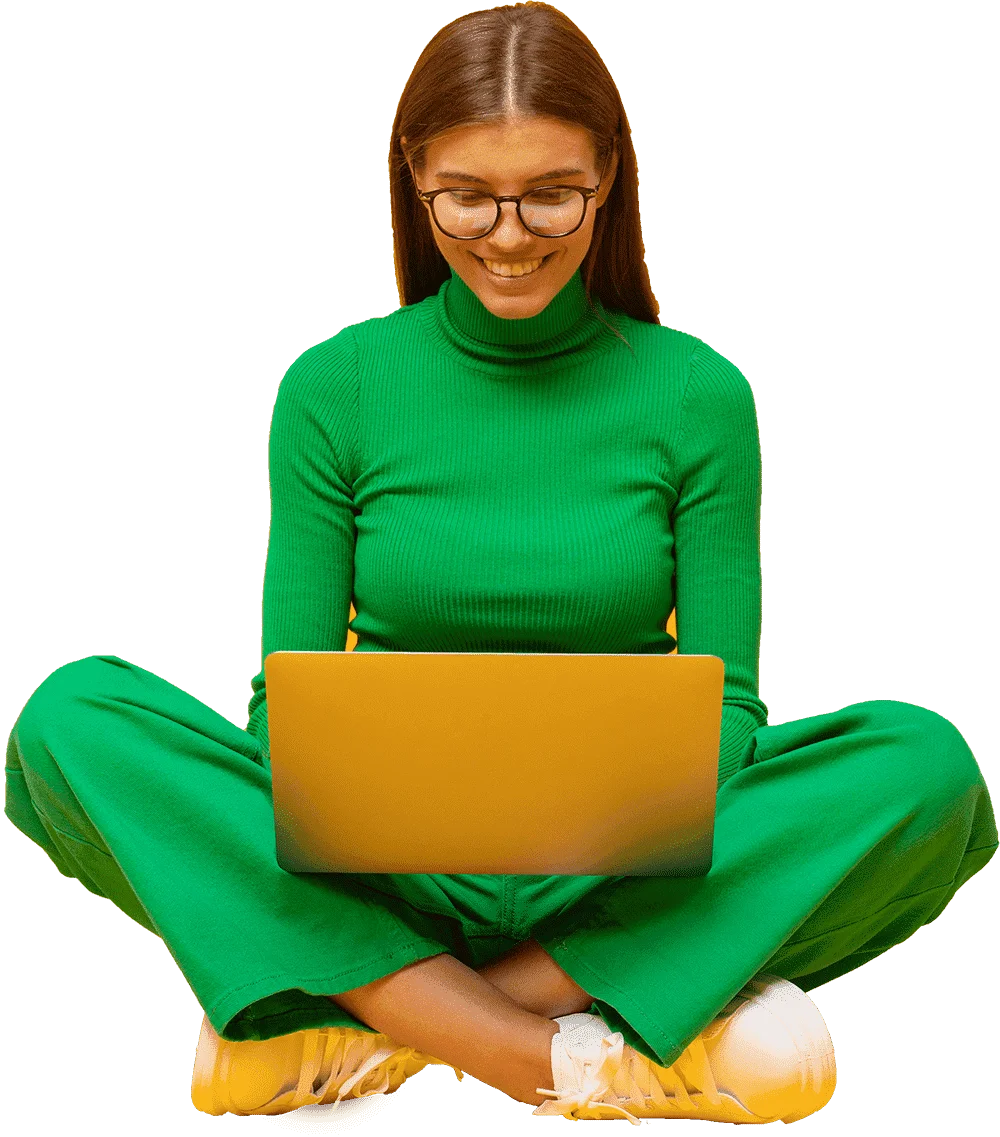 Person sitting with laptop, wearing green.